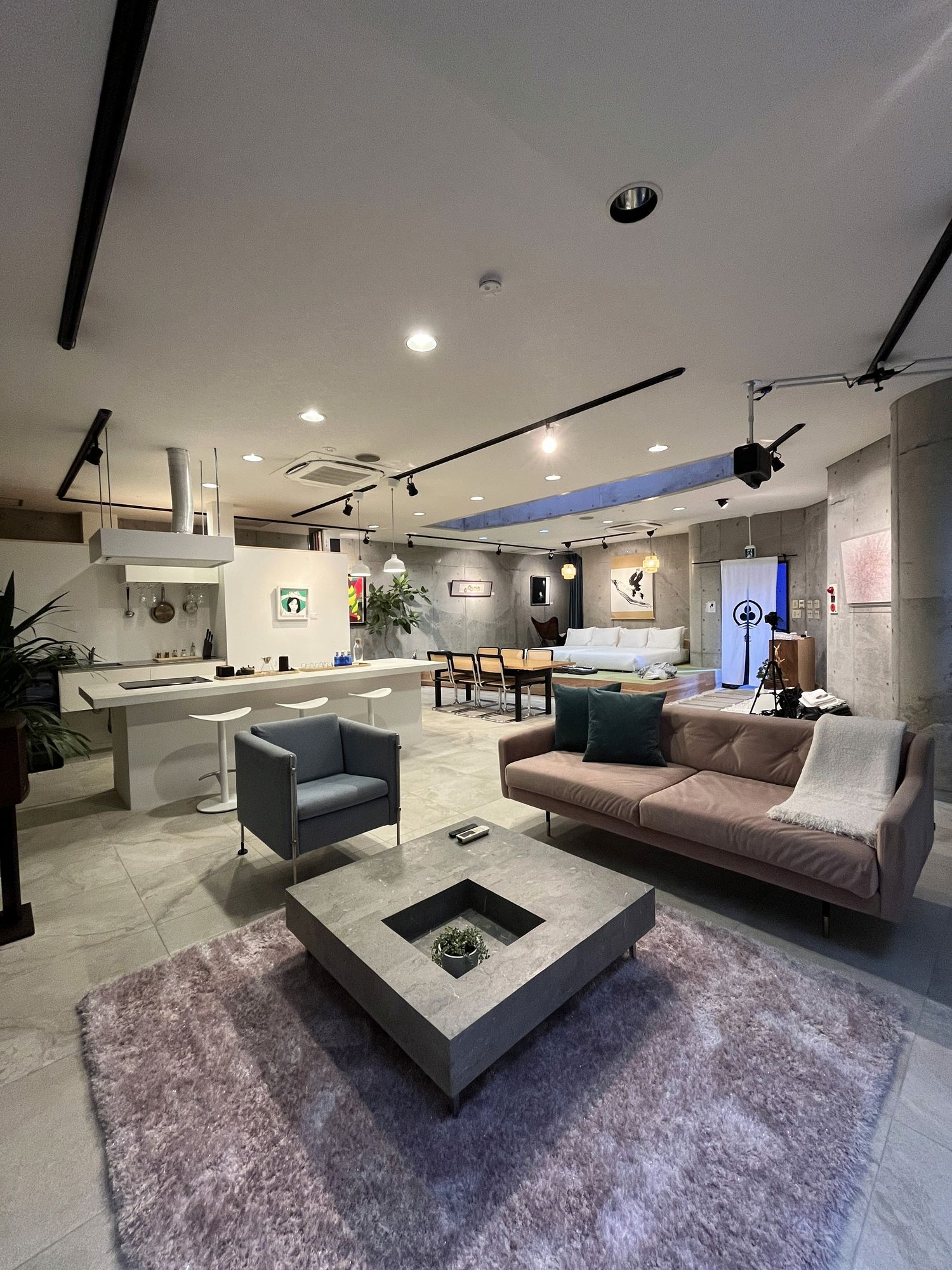 Open lounge with sofas and an industrial ceiling