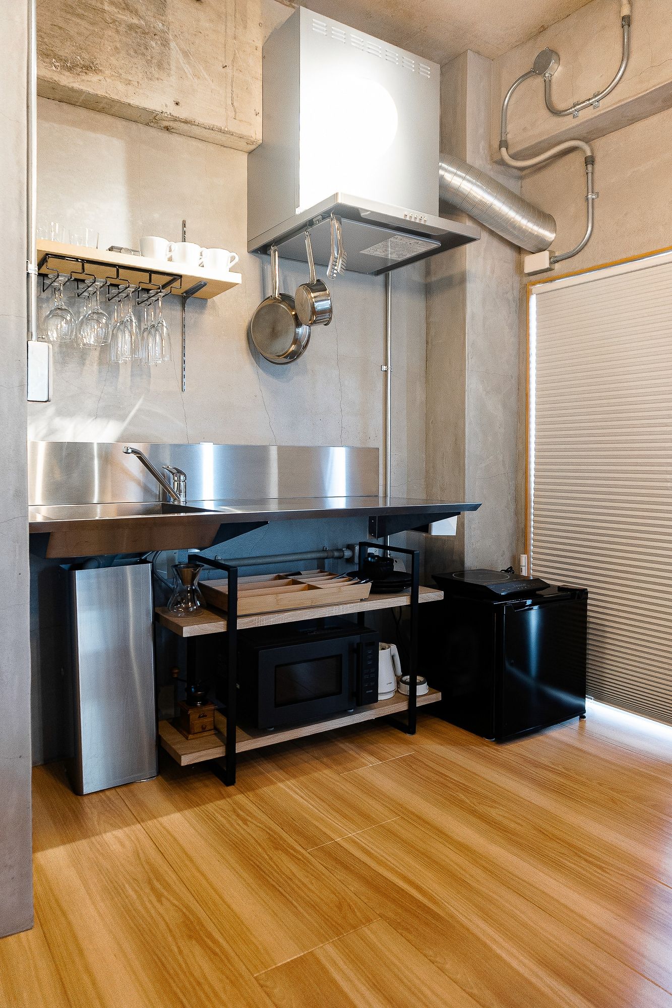 Stainless steel kitchen with a warm wooden floor
