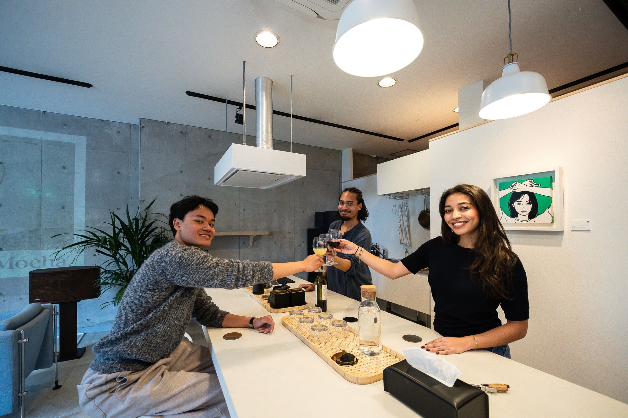 Guests sharing a drink across the counter in a bright SHIKI lounge