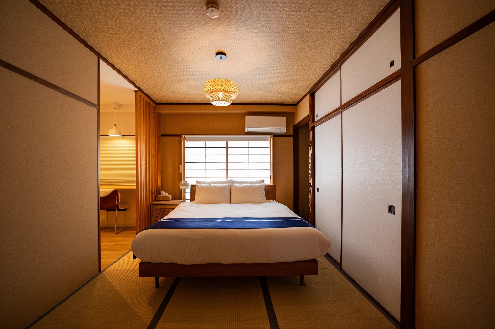 Tatami bedroom seen through open sliding doors, Shiki Villa Beppu