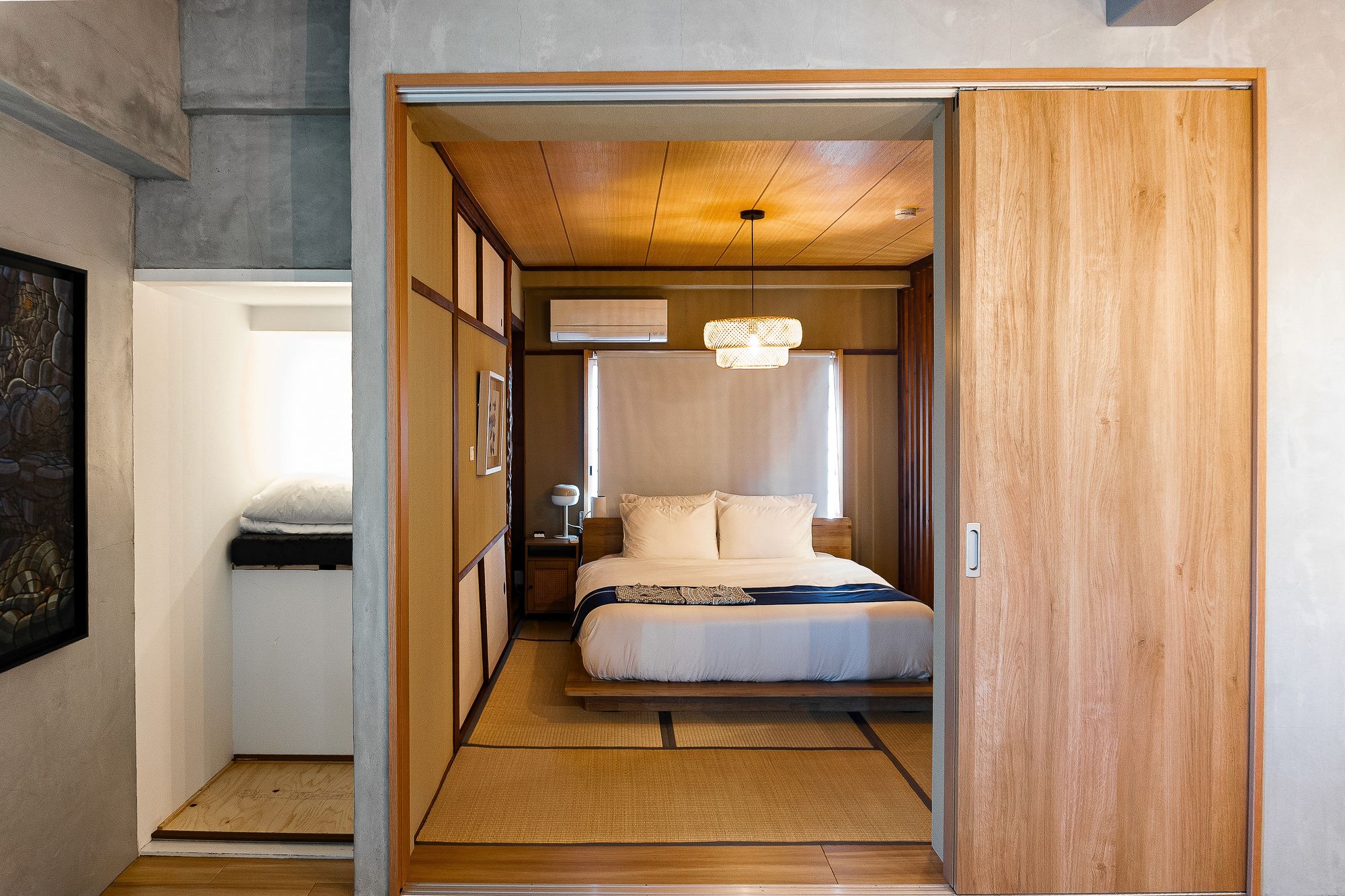 Bedroom seen through a wide timber doorway