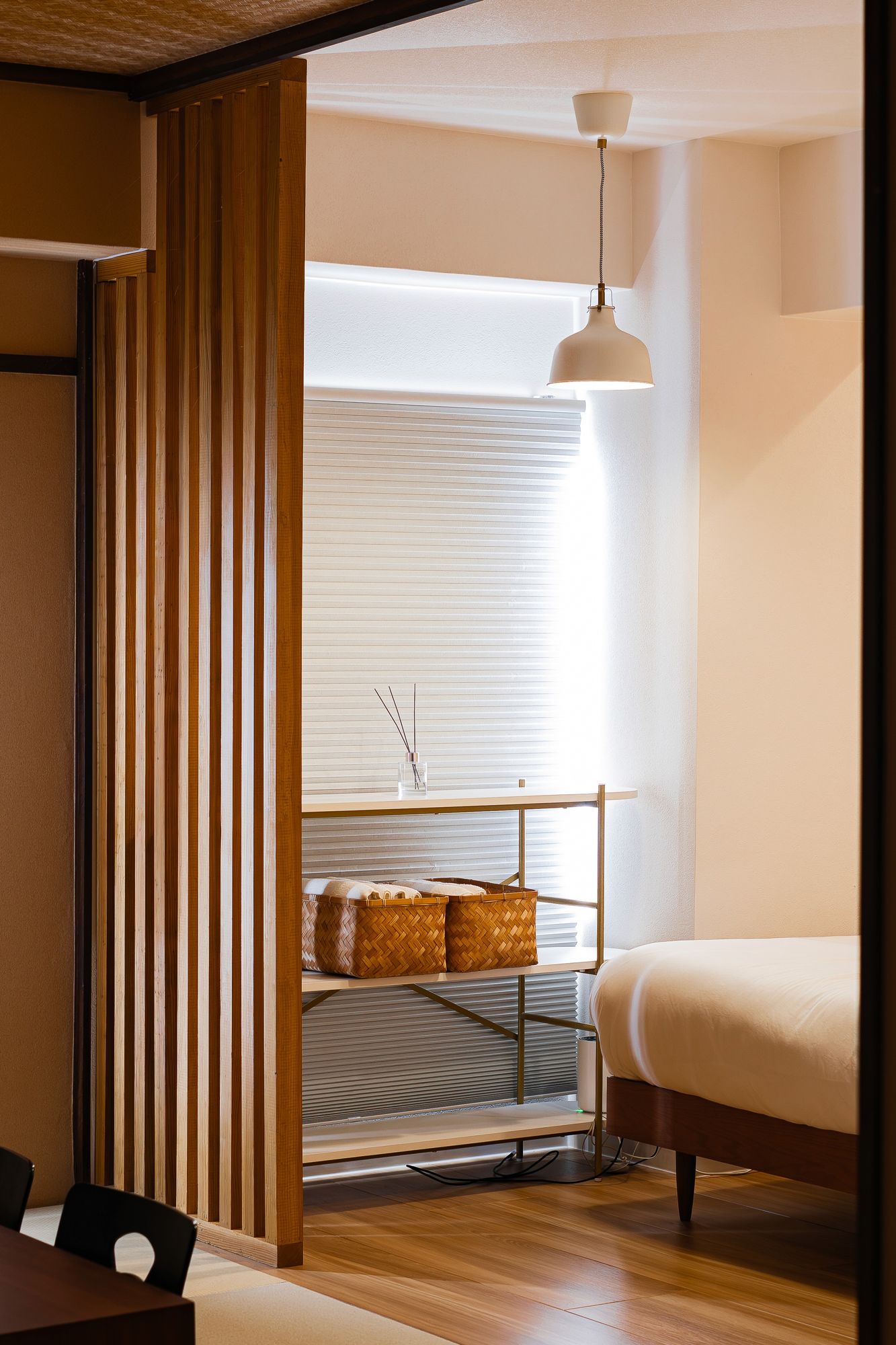 Slatted timber screen dividing a bedroom from the corridor