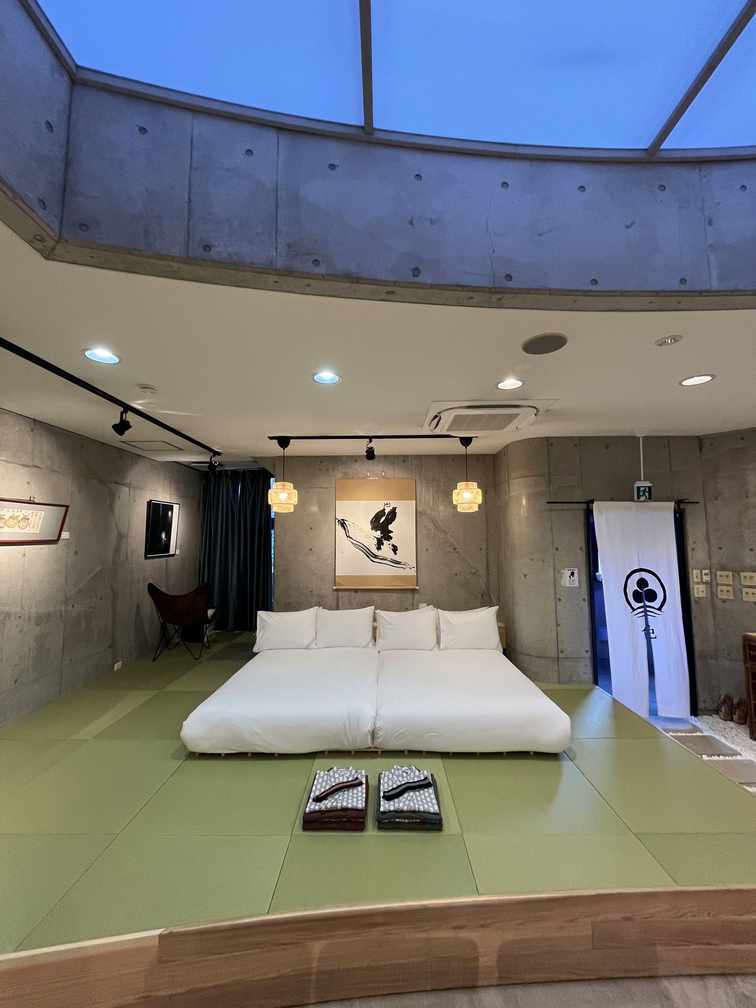 Bedroom beneath a concrete skylight