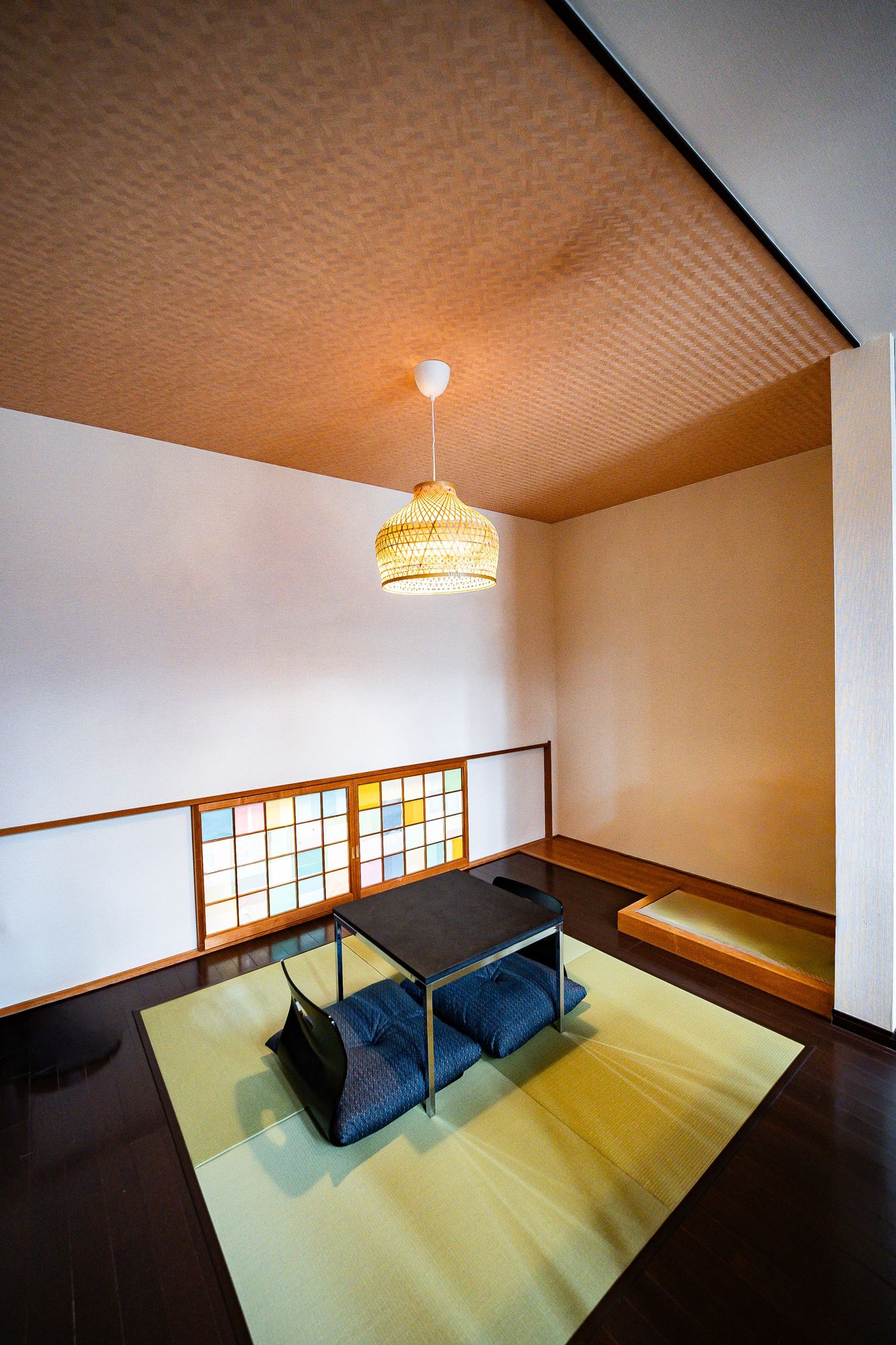 Tatami room with a low navy sofa and a shoji window